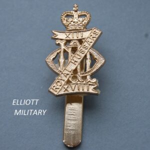 badge with Z shaped scroll with crown above and lettering at the back