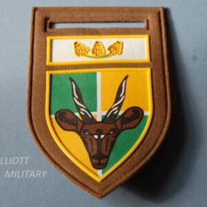 badge with gazelles head on a shield