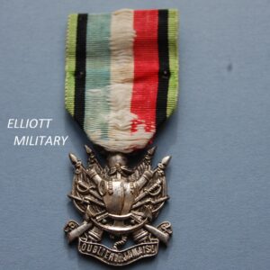 medal with coat of armour on crossed rifles and swords above an anchor and scroll