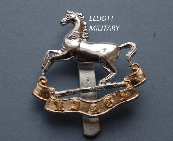 badge with a horse above a scroll reading Kings