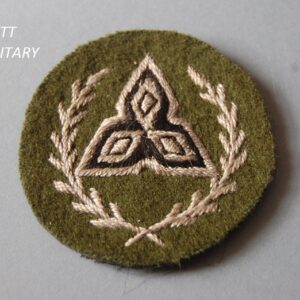 Badge with triangular formation within a wreath
