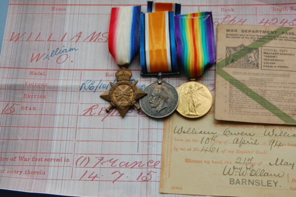three medals with documents