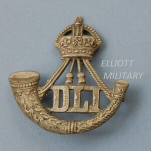 badge with a crown above a strung bugle and letters DLI