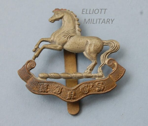 badge with horse above a scroll reading Kings