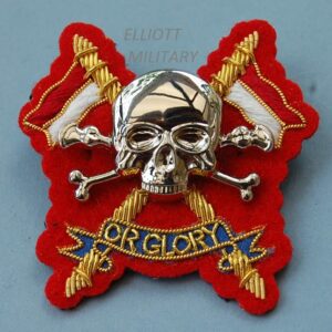 badge with metal scull and crossed bones mounted on cloth backing badge with crossed lances and scroll reading Or Glory