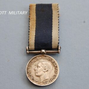 miniature medal with the head of King George the sixth on a blue ribbon with white edges