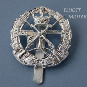 badge with a Vickers machine gun and crossed rifles within a wreath and scroll and a crown above