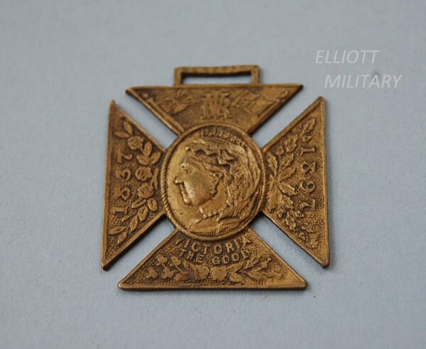 medal in shape of cross with head of Queen Victoria and the dates 1837 - 1897