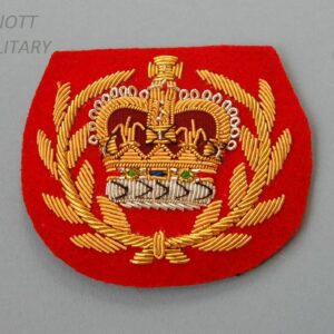 red backed cloth badge with wire embroidery crowm within wreath