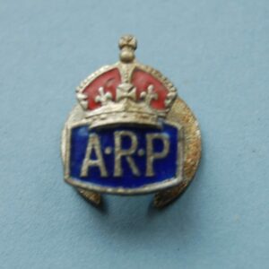 Small buttonhole badge with a crown above the letters ARP on a blue enamel field