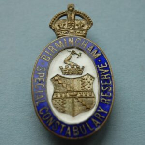 Oval badge with Birmingham City crest below a crown
