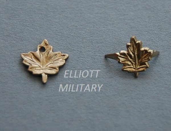 small silver metal emblems of maple leaves