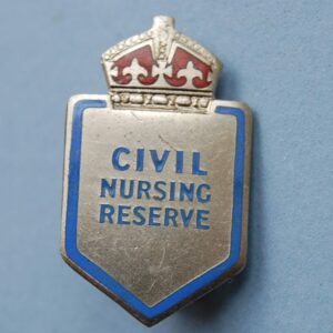 small shield shaped badge with crown above the words CIVIL NURSING RESERVE