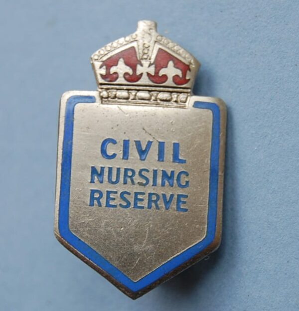 small shield shaped badge with crown above the words CIVIL NURSING RESERVE