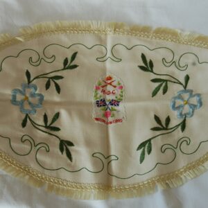 tablecloth with the embroidery reads - Motor Gun Corps with crown above crossed rifles and scroll below with M.G.C. and crossed union flags below.