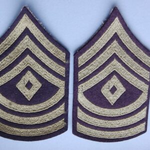 cloth patches with three inverted chevrons above a diamond and three curved stripes