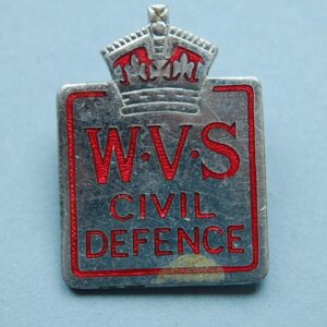 small pin badge with crown above the letters WVA CIVIL DEFENCE in red ename