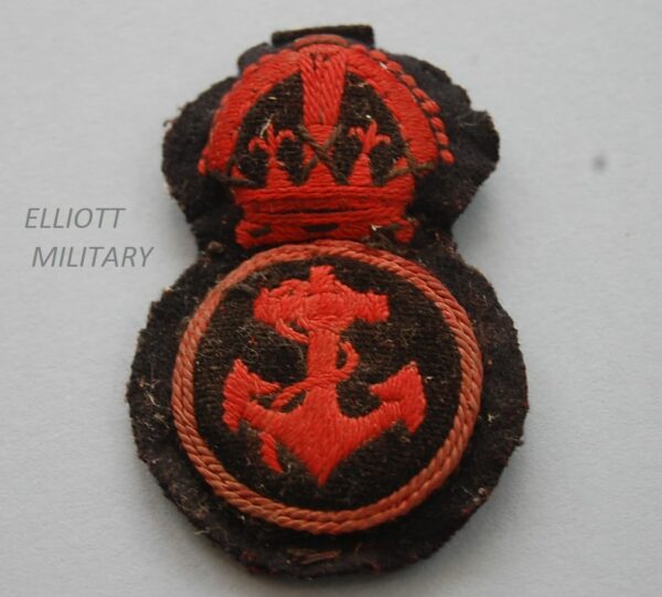 padded cloth badge with red Kings crown above an anchor within a circle on black backing