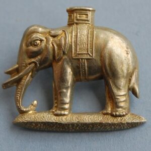 white metal badge with elephant