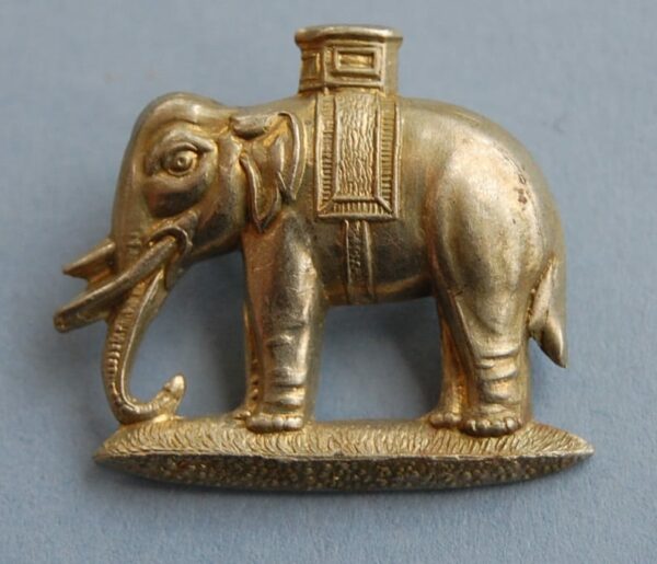 white metal badge with elephant