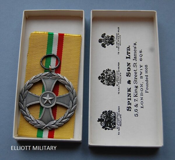 medal with a star within the center of a cross within a wreath