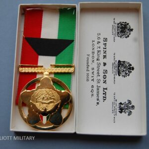 gold coloured medal in box