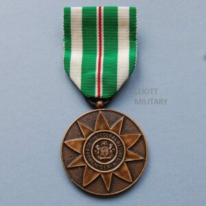 bronze circular medal with Nigerian coat of arms within a circle and star